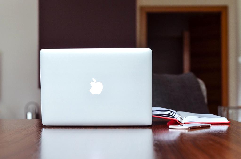 Modern workspace with computer and writing notes